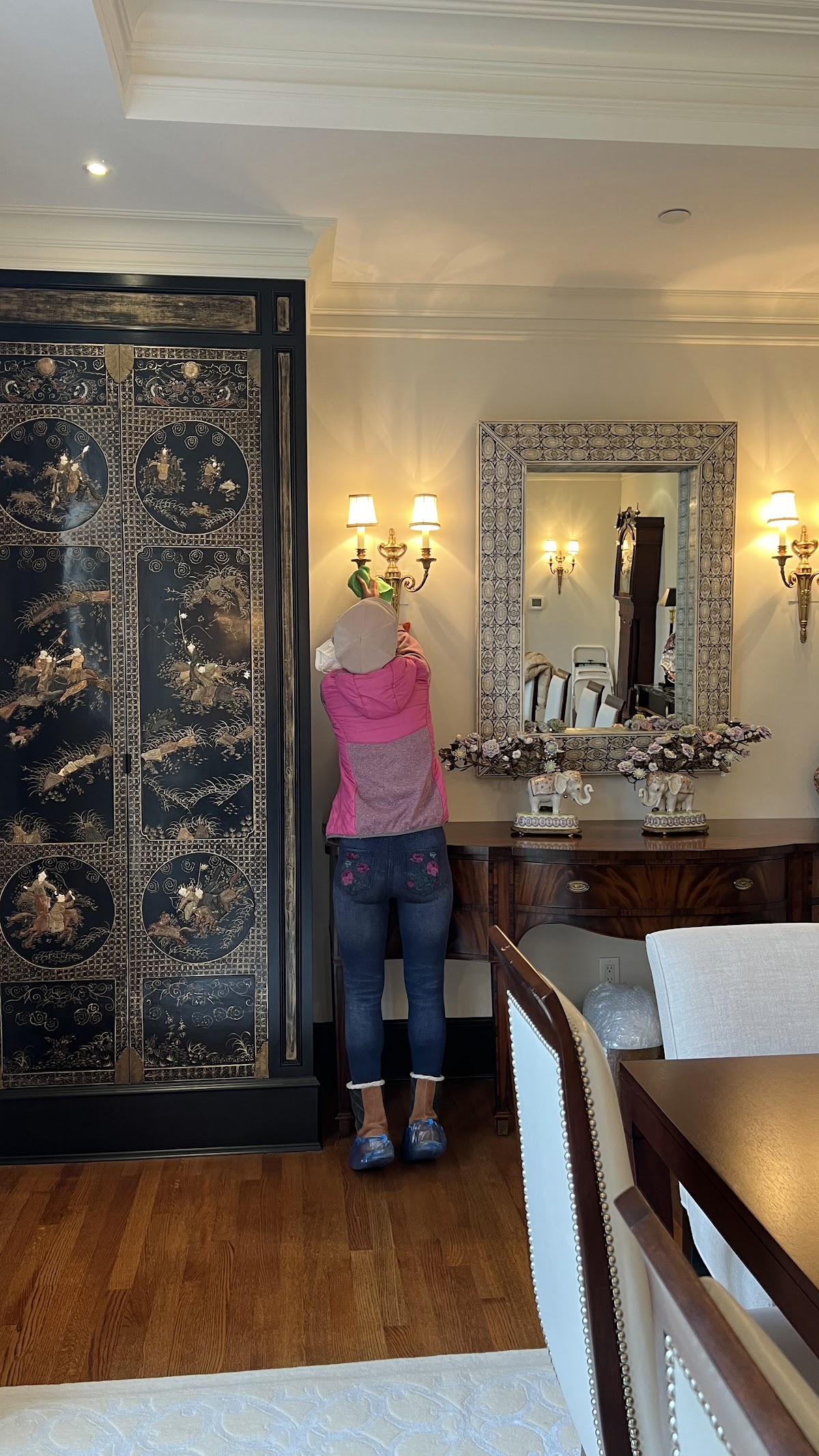 Lily Maid team member carefully cleaning an elegant dining room