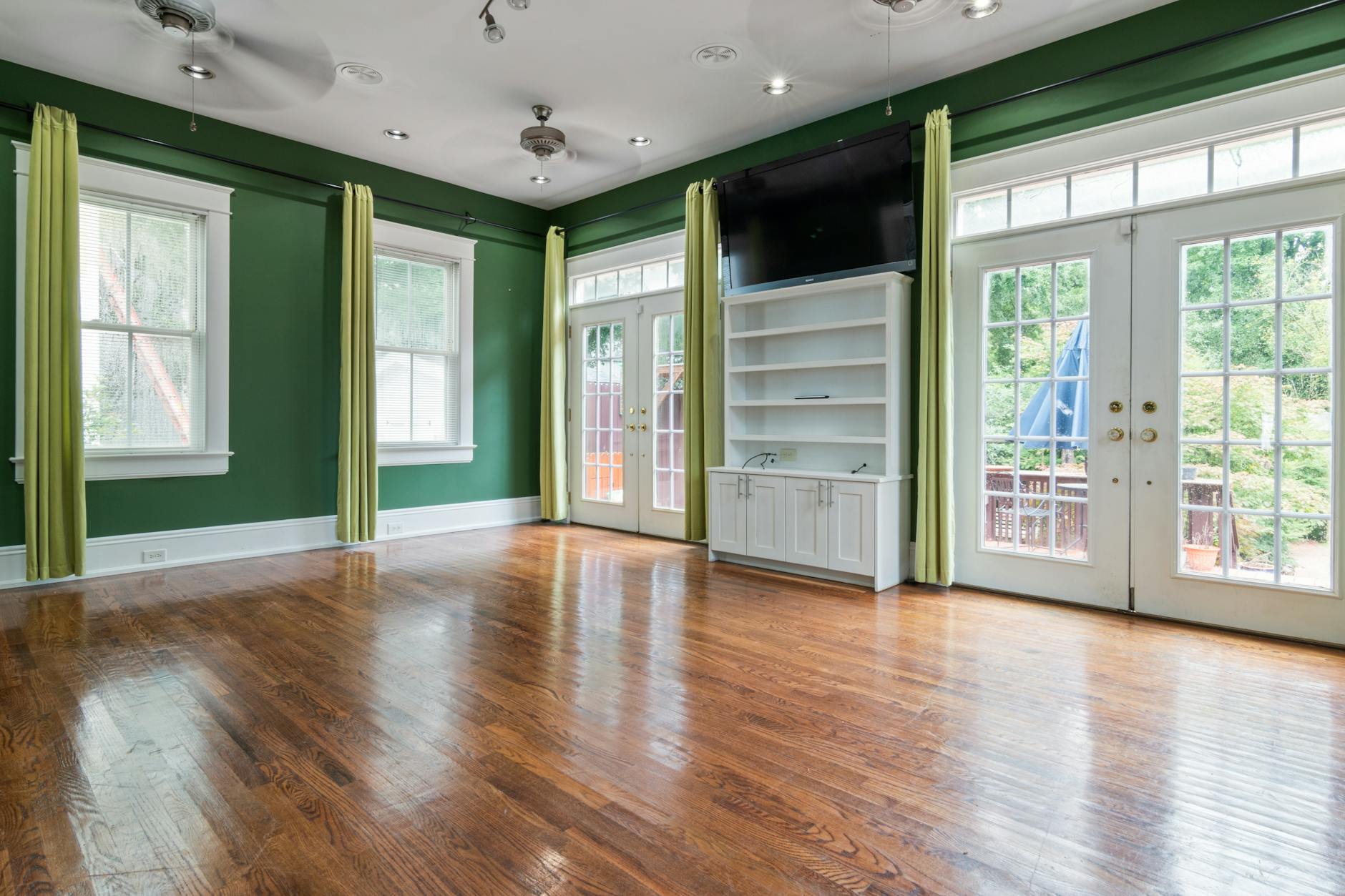 Spotless empty living room with gleaming hardwood floors ready for new tenants